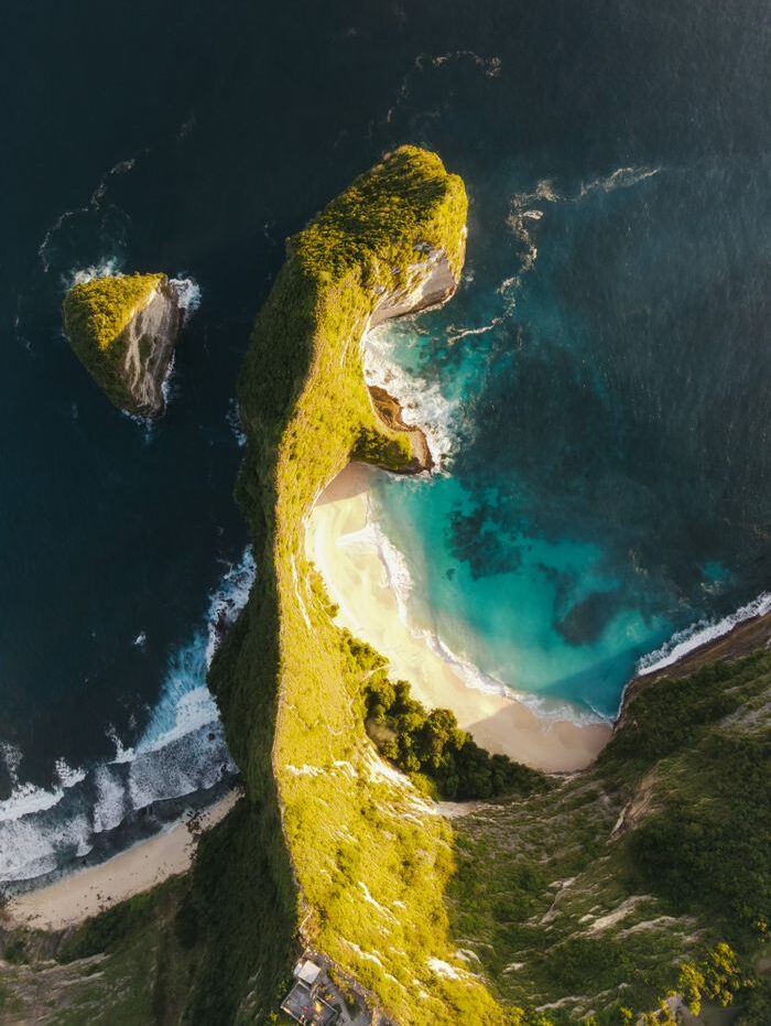 Stunning aerial view of Kelingking Beach on Nusa Penida, Bali, showcasing the iconic cliff and turquoise waters.
